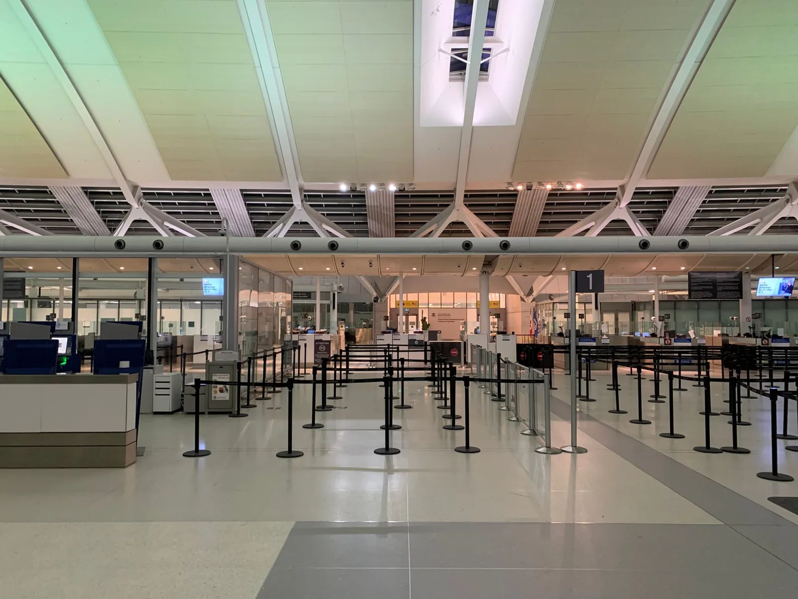 Queue markings on an empty airport floor, suggesting a waiting line that has not moved